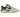 A New Balance sneaker in off-white suede and mesh with black and gray overlays, a green 'N' logo, and a gum outsole, shown from a side profile on a white background.